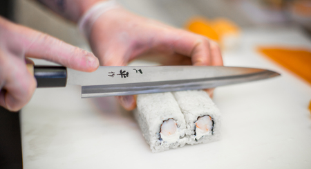 Making sushi rolls. Sushi master, cutting sushi rolls.の写真素材