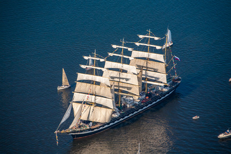 The last windjammer bark Kruzenstern. A large sailboat goes along the water area of the Daugava...