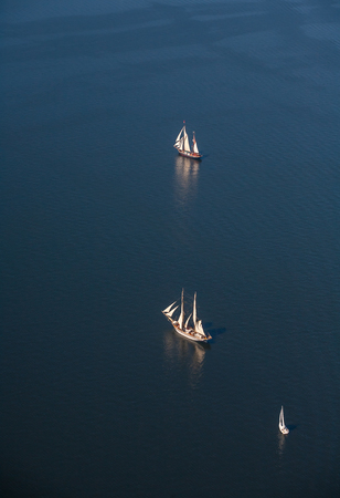 View from above. Several yachts and sailboats go to sea under sail.の写真素材