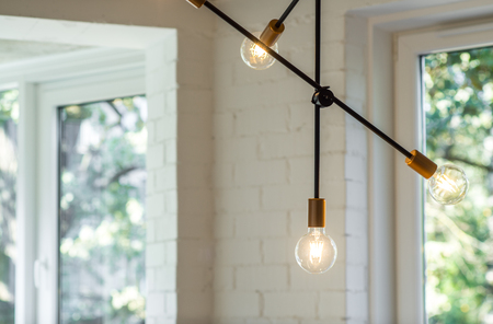 Decoration of the apartments. Chandelier and lighting in a modern apartment.