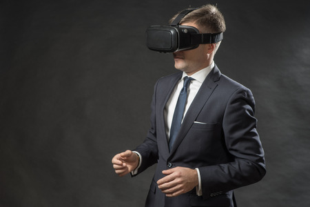 360. Virtual game. Man in black suit uses a virtual reality glasses.  VR