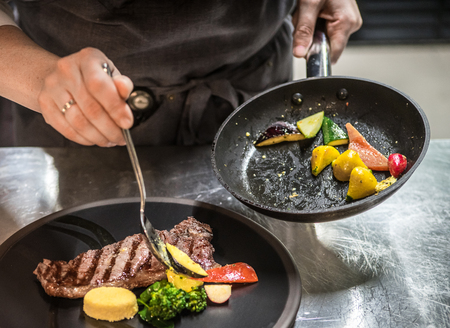 Preparing to serve. Chef puts the dish on a plate.の写真素材