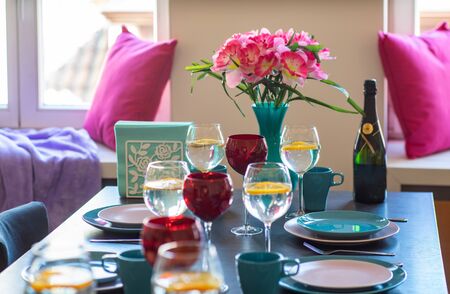 Crockery on the table. Blue and white plates. Wine glasses.