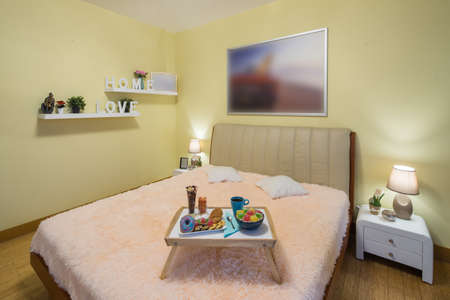 Light spacious studio apartment. Furniture and tv. Table with food.