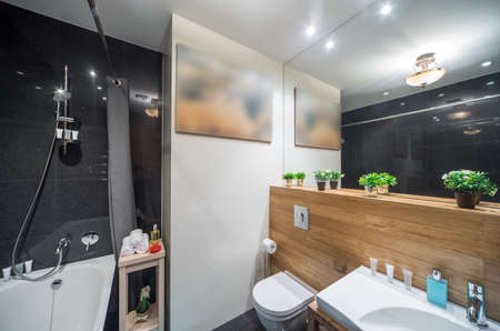 Light spacious studio apartment. Two grey sofas. Table with food.