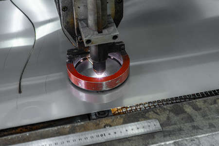 Close-up of metal processing machine. Plasma metal cutting. Production of metal pipes.