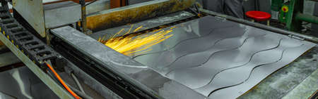 CLose-up of working metal processing machine. Plasma metal cutting. Production of metal pipes.
