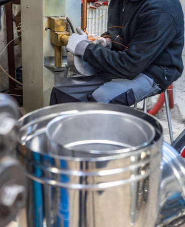 Spot welding machine. Welding of pipes for chimneys. Working welder. Bright sparks.の写真素材