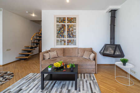 Modern interior of living room in luxury studio apartment. Cozy sofa. Fruits on the table....