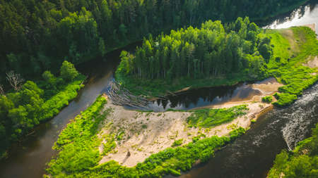 Top drone landscape of summer forest and the river with fast flow. Green trees. Beautiful latvian nature.の写真素材
