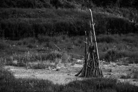 Woodpile of dry branches is standing on the sand. Huge fire preparation. Midsummer Ligo celebration. Close-up.の写真素材