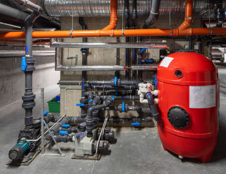Interior of modern boiler room. Piping system. Red boiler unit.の写真素材