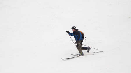 Ski resort. The skier quickly rides down a snow-covered professional track. White snow. Professional sport.の写真素材
