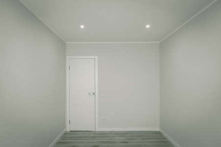 Modern light interior of empty room without furniture. Stylish apartment after renovation. Front...