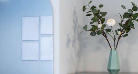 Modern interior of apartment. Flowers in vase. Mirror on wall.の写真素材