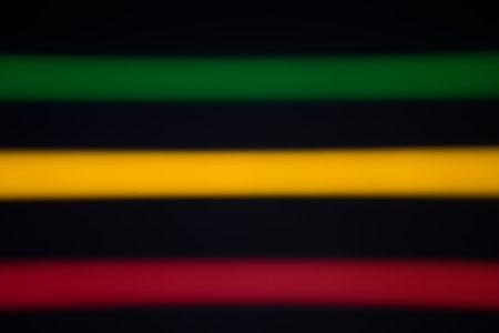 Blurred stripes of neon lights. Green, yellow and red colors.の写真素材