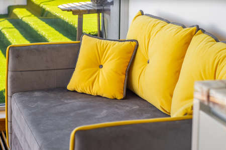 Grey and yellow sofa. Coy furniture in modern interior.の写真素材