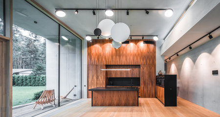 Modern interior of wooden kitchen in luxury private house. Garden view.の写真素材