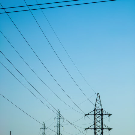High voltage electricity power line towers against the sky. Transmission towers