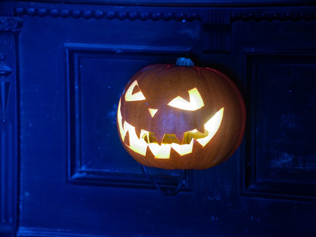 Halloween pumpkin lantern with scary face glowing inside. Decoration.の写真素材