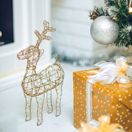 Christmas spirit. Festive decorations. Beautifully wrapped gifts. Wire deer.の写真素材