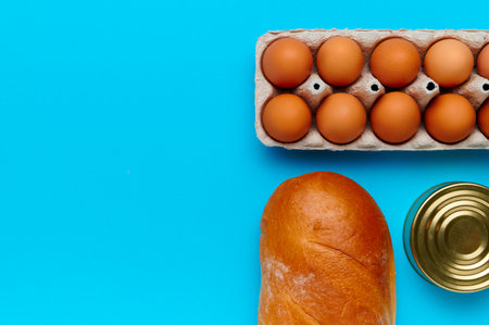 Top view, flatlay, computation. Set of products on the blue background. Packaging food from the...