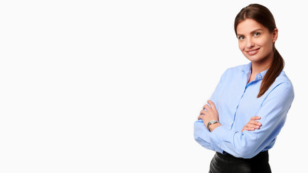 Confident crossed arms business woman in blue shirt on white isolated backgroundの写真素材