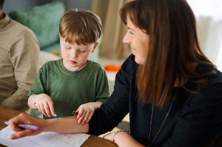 Happy family. Mother with little son painting and drawing together. Caucasian boy with his mother...