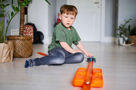 Young preschool boy play with toy and have fun at homeの写真素材