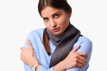 Health concept. Sick upset caucasian woman with scarf on white isolated backgroundの写真素材