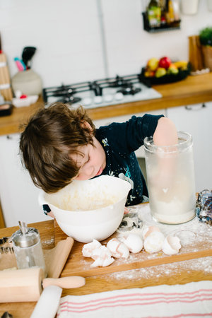 Son helps mother cook in the kitchen. High-quality photoの写真素材