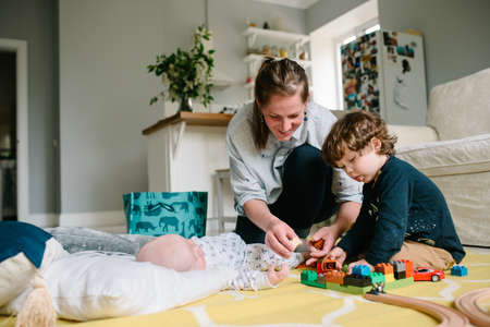 Mother playing with son on the floor at home