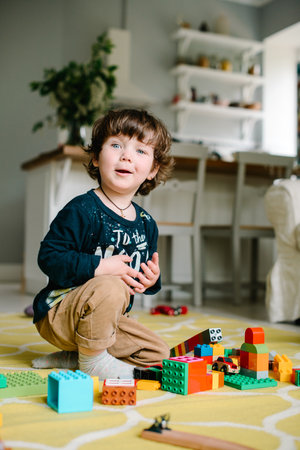 Boy playing with building blocks at home on the floor. High quality photoの写真素材