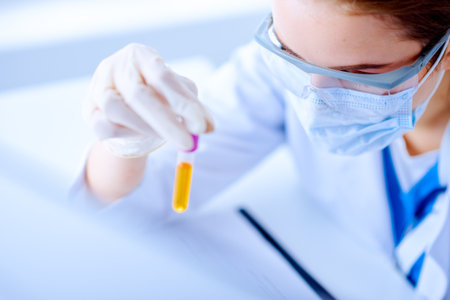 Female doctor holding stethoscope in medical office and smileの写真素材