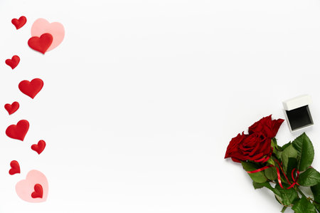 Bouquet of roses, many hearts and box for ring on white background. Top view, flat layの写真素材