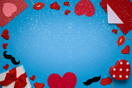 Valentine's day banner template with red envelope, valentine gift, lips decor on blue background with copy space. Top view, flat layの写真素材