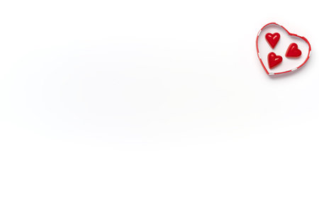 Gift box heart shape with chocolate sweets inside over white isolated background