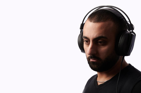 Young arabian man dj with headphones on isolated backgroundの写真素材