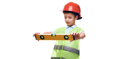 building, construction and profession concept - little caucasian boy in protective helmet and safety...