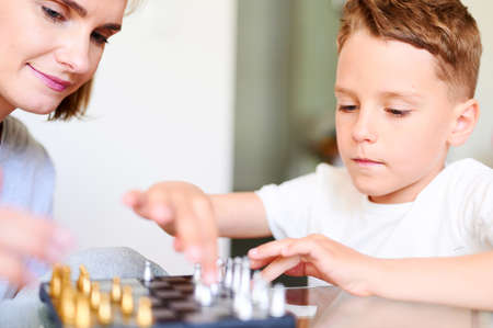 Caucasian Mother And little Son Playing Chess At Homeの写真素材