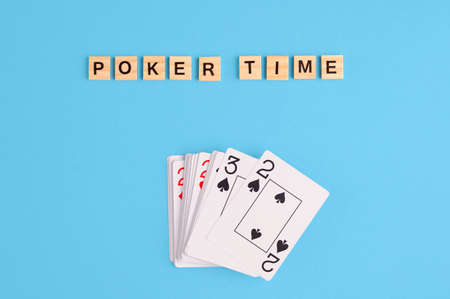 Poker Playing Cards on blue background with wooden blocks. Flatlay, copy space, conceptの写真素材
