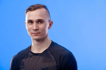 Portrait of muscular caucasian handsome man with strong body on blue background. healthy lifestyle...
