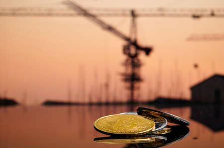 Cryptocurrency bitcoin ethereum coins on stack on building blurred background. Concept blockchain, new virtual money, cryptocurrency miningの写真素材