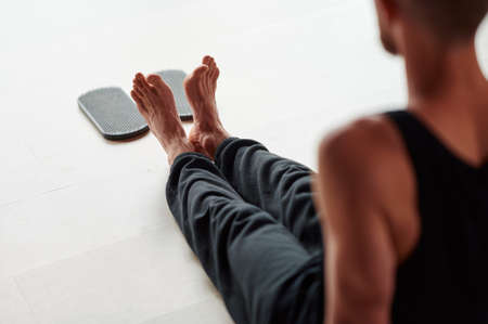 Mans legs after standing on sadhu board with sharp nails. Male relaxe after yoga practice sitting on the floor in studio indoorsの写真素材