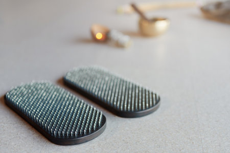 Black sadhu board with sharp nails on the floor in yoga studio. Alternative medicine acupressure, recovery strengthの写真素材