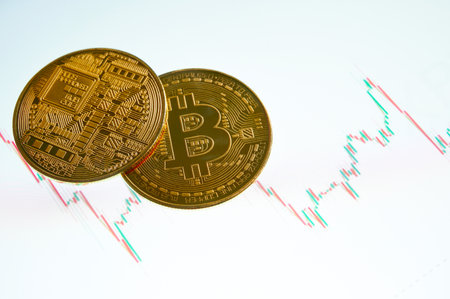 Bitcoin gold coin on screen with stock graph. Cryptocurrency. Bitcoin Stock Growth. Virtual cryptocurrency concept. Investing in virtual assets. Investment platform with charts and bitcoin coin.の写真素材
