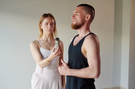 Practice of standing on nails. Couple of people meditation while standing on sadhu board in yoga studio. Concept on healthy lifestyle.の写真素材
