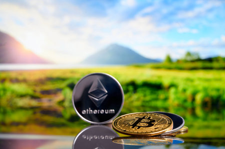 Cryptocurrency bitcoin ethereum coins on stack on nature blurred background. Concept blockchain, new virtual money, cryptocurrency miningの写真素材