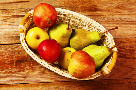 Nature theme with fruit and basket on wooden background. Nature fruit concept.の写真素材
