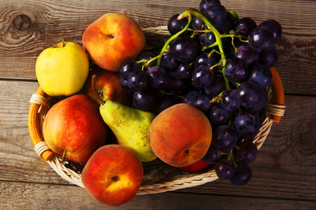 Nature theme with fruit and basket on wooden background. Nature fruit concept.の写真素材